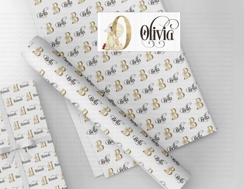 May include: White wrapping paper with a repeating pattern of the letter "B" and the name "Bella" in black script. A roll of paper and a wrapped gift are also visible. The name "Olivia" is also displayed.