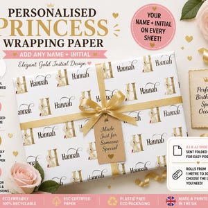 May include: Personalised princess wrapping paper with a gold ribbon and tag. The white paper features a repeating pattern of the name "Hannah" and a gold initial "H" with a belle-inspired design. The wrapping paper is perfect for birthdays and special occasions.