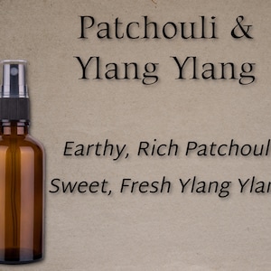 May include: A brown glass bottle with a black spray nozzle filled with essential oil. The label reads "Patchouli & Ylang Ylang" and describes the scent as "Earthy, Rich Patchouli Sweet, Fresh Ylang Ylang".