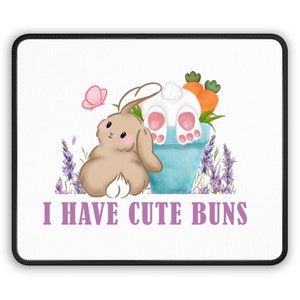May include: A white bunny with brown ears sits in a blue pot with carrots and green leaves. A brown bunny with pink ears sits next to the pot. Lavender flowers and a pink butterfly are in the background. The text "I HAVE CUTE BUNS" is below the bunnies.