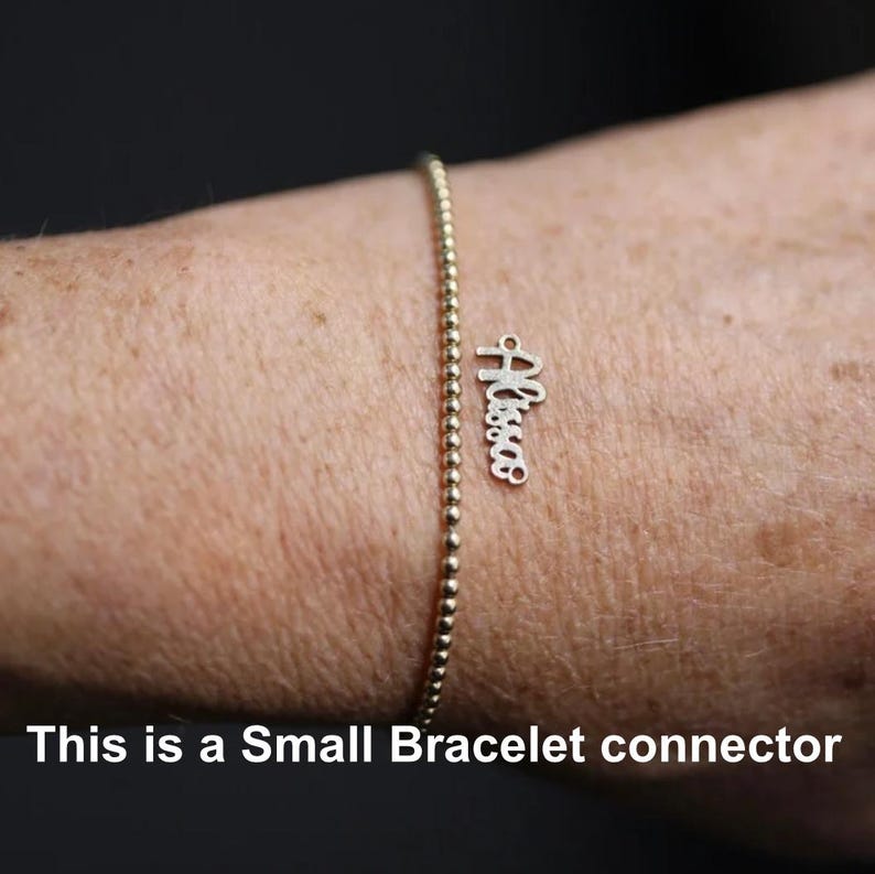 May include: A gold-colored beaded bracelet with a small charm that spells out the name "Alyssa" in a cursive font. The bracelet is shown on a person's wrist. The text at the bottom of the image says "This is a Small Bracelet connector."