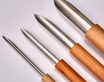 Könnte beinhalten: Vier unterschiedlich große Metallwerkzeuge mit Holzgriffen. Die Werkzeuge werden zum Schnitzen und Modellieren verwendet.