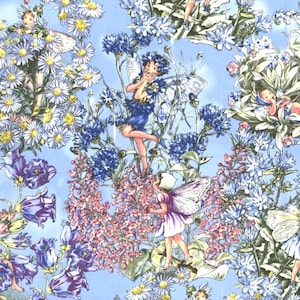 May include: A whimsical fabric design featuring fairies amidst a field of flowers. The illustration showcases fairies in various poses, surrounded by blue cornflowers, daisies, and other blooms. The color palette includes shades of blue, purple, pink, and white against a light blue background.