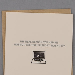 May include: A white card with a brown envelope. The card has a black and white illustration of a laptop with a cracked screen. The text on the card reads "THE REAL REASON YOU HAD ME WAS FOR THE TECH SUPPORT, WASN'T IT?"