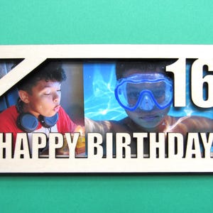 May include: A wooden photo frame with a white background and a cutout design. The frame has two photos, one of a person blowing out a candle and another of a person swimming. The frame says "Happy Birthday" and "16" in white letters.