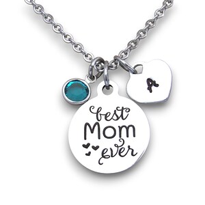 May include: Silver necklace with a round charm that says "best mom ever" with two small hearts, a teal blue crystal charm, and a heart charm with the letter "A" engraved on it.