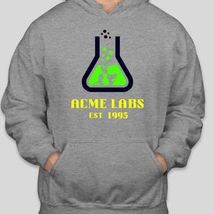 May include: A gray hooded sweatshirt with a green and blue graphic of a beaker with bubbles and the text "ACME LABS EST 1995".