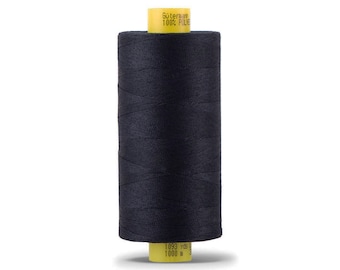 May include: A spool of black thread with a yellow label that reads " Gütermann 100% Polyester 1093 yds 1000 m "