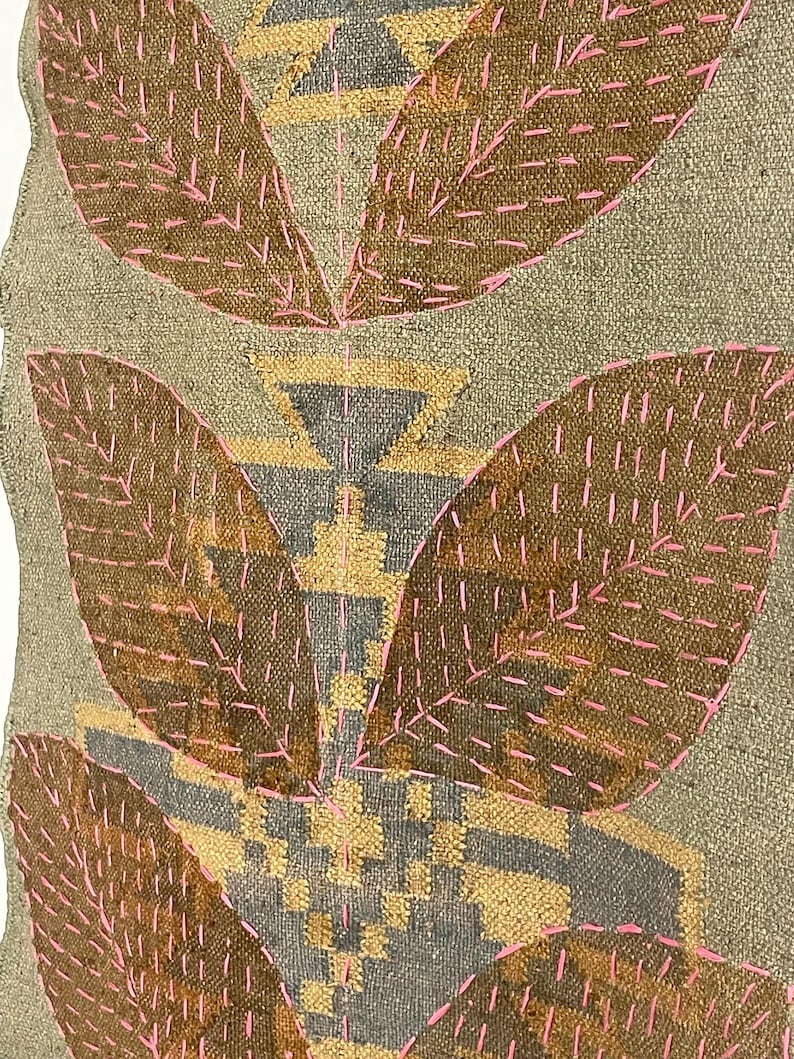 May include: Textile art with a neutral backdrop, featuring large, leaf-like forms in brown, highlighted with pink stitching. The design incorporates geometric patterns in gold and grey.