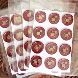 May include: Sheets of red wax seals with gold embossed designs, including a wolf, a face, and a square with an arrow. The seals are packaged in clear plastic bags, ready for use.