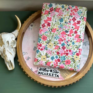 May include: A wooden tray with a floral pattern on the inside. A fabric with a floral pattern is on top of the tray. The fabric has the text "Willow*Star MARKET" on it.