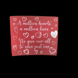 May include: A red background with white hearts and the text "A million hearts, a million lives We give our all to save just one" in a handwritten font.