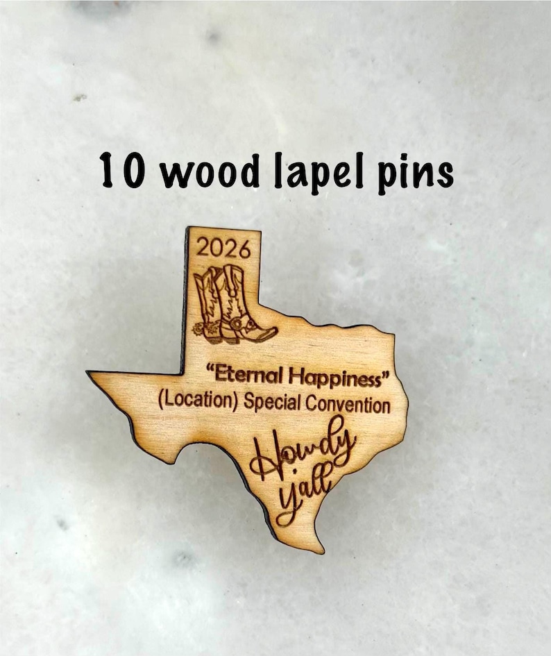 May include: Ten wooden lapel pins in the shape of the state of Texas. The pins are engraved with the text "2026", cowboy boots, and "Howdy Y'all". The pins also include the text "Eternal Happiness (Location) Special Convention".