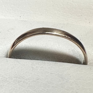 May include: A plain silver wedding band.