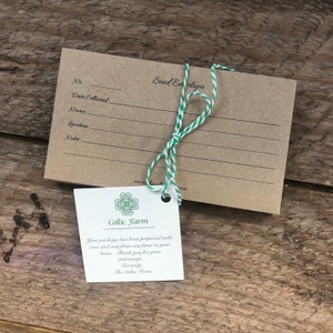 May include: A brown paper seed envelope with a white and green twine tied around it. The envelope has a blank space for the date collected, name, location, and notes. A small white tag with a green shamrock and the text "Celtic Farm" is attached to the envelope. The tag includes a message thanking the customer for their patronage.
