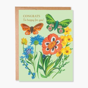 May include: A greeting card with a light green background, featuring colorful illustrations of butterflies and flowers. The card reads "CONGRATS So happy for you!" in gold lettering. The card is inside a brown envelope.