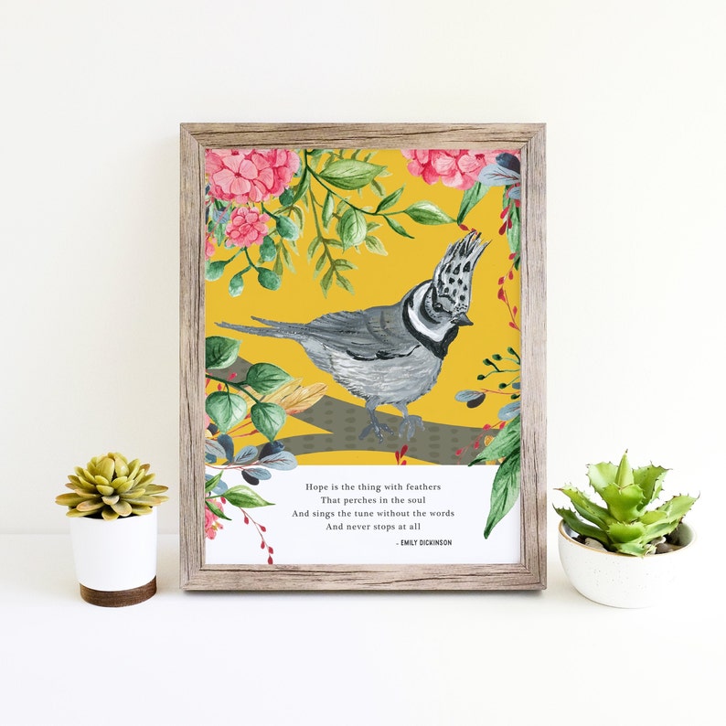 May include: A printable art print featuring a watercolor illustration of a bird with gray and white feathers perched on a branch with pink flowers. The background is yellow and the print includes a quote by Emily Dickinson: "Hope is the thing with feathers That perches in the soul And sings the tune without the words And never stops at all."
