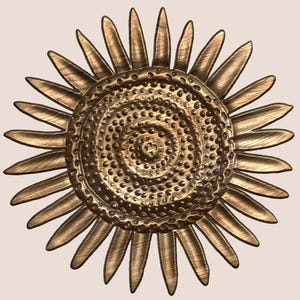 May include: A gold metal sunflower wall decor with a textured centre and a hammered finish.