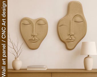 May include: Two beige wall art panels in the shape of faces with closed eyes. One is heart-shaped, the other is an abstract form. The panels are mounted on a light beige wall. The text "Wall art panel / CNC Art design" is on the left side.