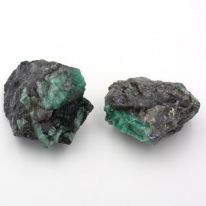 Two rough emeralds of 171 and 192 grams with a quartz and mica matrix.