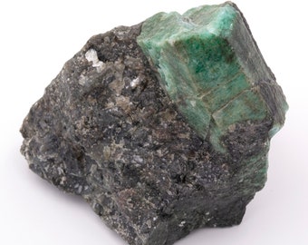 Raw emerald stone of 511 grams with matrix of quartz and black mica.
