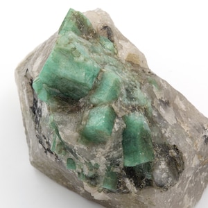 Rough emerald of 345 grams with quartz and mica matrix.