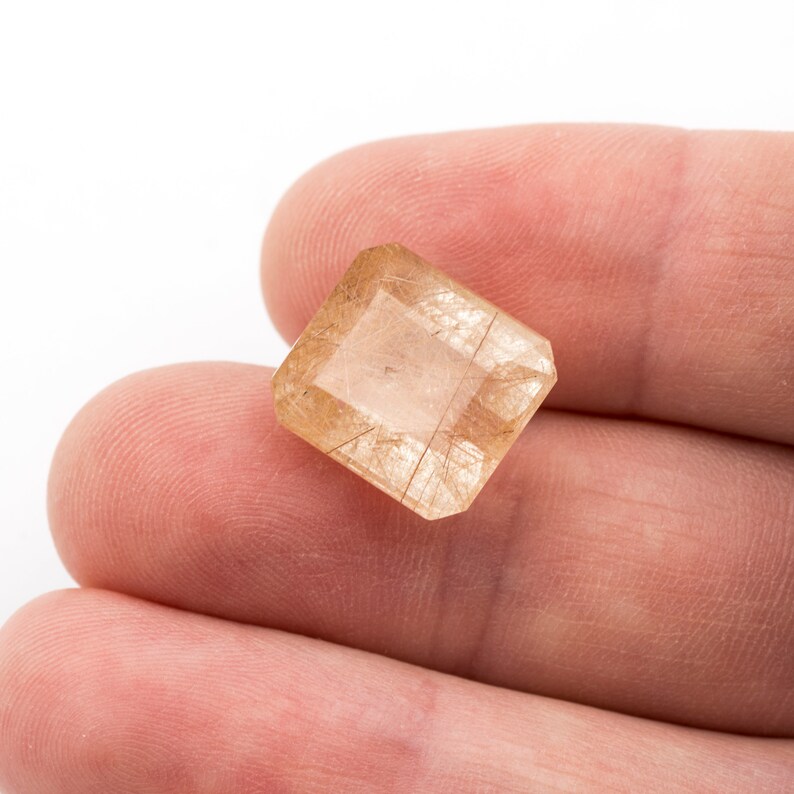 weight Measurements 14.25 x 12.71 x 8.61 mm. 12.05 ct Rectangular emerald-cut natural rutilated quartz