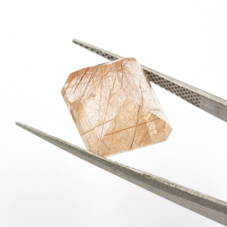 weight Measurements 14.25 x 12.71 x 8.61 mm. 12.05 ct Rectangular emerald-cut natural rutilated quartz