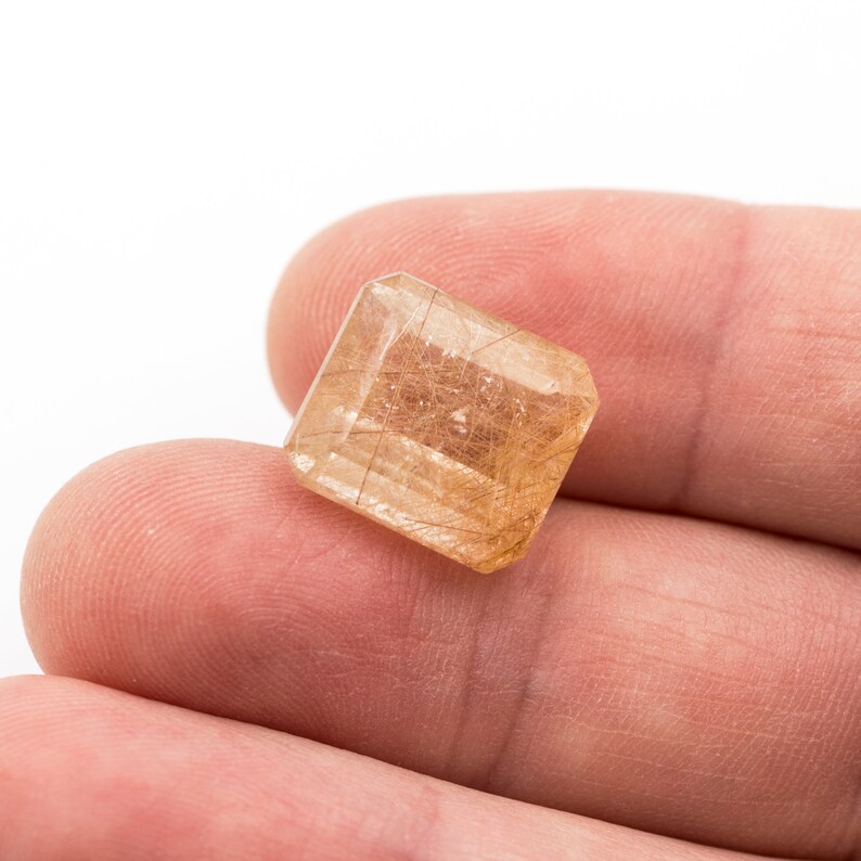 weight Measurements 14.25 x 12.71 x 8.61 mm. 12.05 ct Rectangular emerald-cut natural rutilated quartz