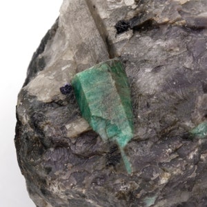 Rough emerald weighing 585 grams with quartz and mica matrix.