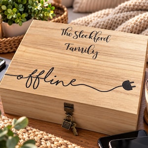 May include: A rectangular light-coloured wooden box with a hinged lid and a metal latch secured by a small padlock and key. The lid features black text reading The Stockford Family and the word offline with a graphic of an electrical plug.