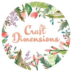 May include: A white circle with a floral border and the text "Craft Dimensions" in a peachy-orange color.