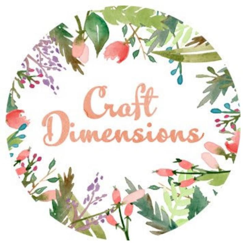 May include: A white circle with a floral border and the text "Craft Dimensions" in a peachy-orange color.