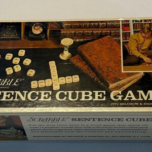 May include: Vintage Scrabble Sentence Cube Game box. The box features the game title in large letters, along with an image of people playing the game. The box also includes the game's components, such as dice and a cup.