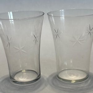 May include: A set of three ceramic mugs with a speckled, matte finish. The mugs are in shades of cream, light gray, and dark gray. Each mug has a simple, minimalist design, perfect for coffee or tea.