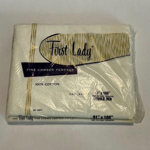 May include: A packaged white double bed sheet by First Lady. The sheet is made of fine combed percale and 100% cotton. The package is labeled "81" x 108" size before hemming".