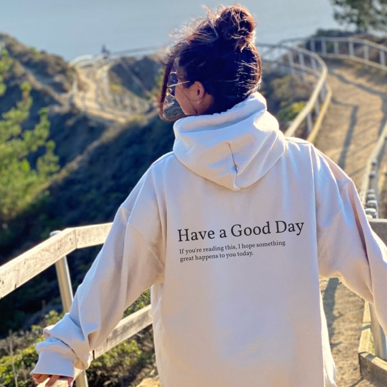 May include: A white hoodie with the text "Have a Good Day" and the message "If you're reading this, I hope something great happens to you today." printed on the back.