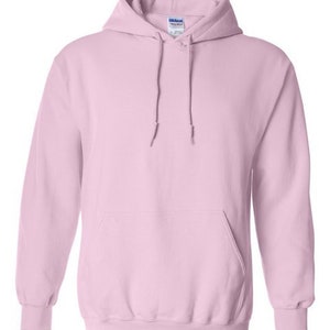 May include: A light pink hooded sweatshirt with a pouch pocket. The sweatshirt has a Gildan brand tag on the inside of the hood.