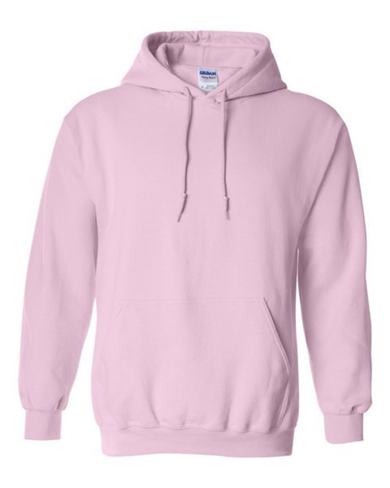May include: A light pink hooded sweatshirt with a pouch pocket. The sweatshirt has a Gildan brand tag on the inside of the hood.