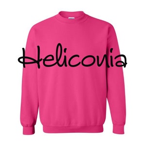 May include: A pink sweatshirt with the word "Heliconia" written in black cursive on the front.