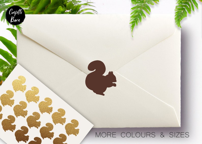 May include: A brown squirrel sticker on a cream-colored envelope. A sheet of gold glitter squirrel stickers is in the lower left corner. The text "MORE COLOURS & SIZES" is at the bottom.