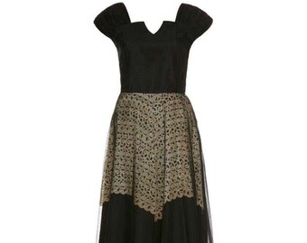 May include: A black and gold vintage dress with a fitted bodice and a full skirt. The skirt is made of tulle with a gold embroidered pattern.