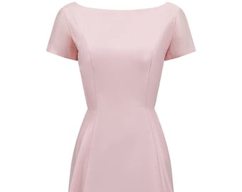 May include: A light pink sleeveless dress with a boat neck and a fitted bodice. The dress has a flared skirt and a simple design.