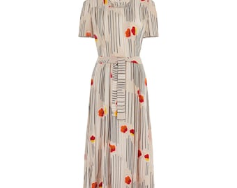 May include: A beige midi dress with short sleeves and a matching belt. The dress features vertical black stripes and red and yellow floral accents. The dress is a classic, elegant style.