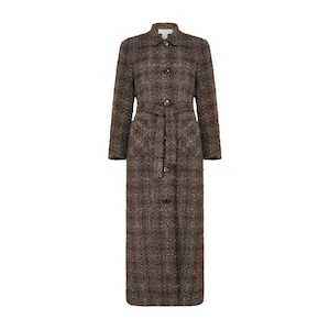 May include: A long, brown tweed coat with a subtle plaid pattern. The coat features a button-down front, a belted waist, and a classic collar. The coat is floor-length and has long sleeves.