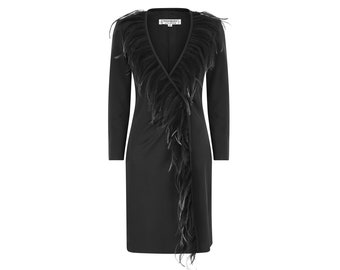 May include: A black wrap dress with a long sleeve and a feather trim around the neckline. The feather trim extends down the front of the dress.