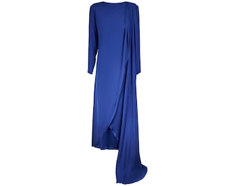 May include: A long-sleeved, royal blue dress with a draped design. The dress has a high neckline and a flowing, asymmetrical hem.
