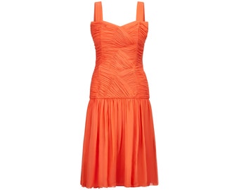 May include: A bright orange sleeveless dress with a fitted bodice and a flowing skirt. The bodice has a pleated design and the skirt has a tiered ruffle.