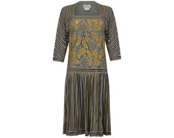 May include: A gray and gold striped dress with a floral pattern on the bodice. The dress has a square neckline and three-quarter sleeves.