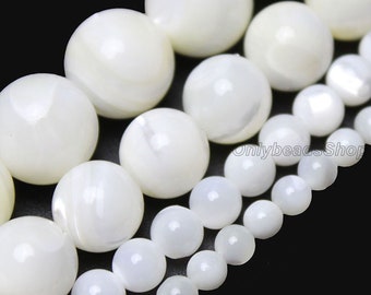 May include: A strand of white mother of pearl beads in various sizes. The beads are round and have a smooth, polished finish.